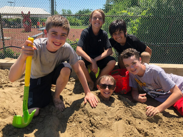 dude-camp kids at camp playing in the sand